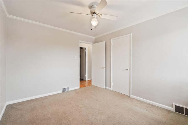 unfurnished bedroom with light carpet, crown molding, a closet, and ceiling fan