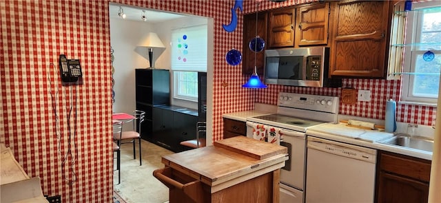 kitchen with tasteful backsplash and white appliances