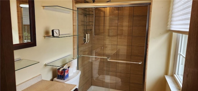 bathroom with vanity, toilet, and walk in shower