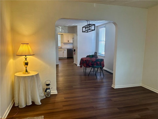 corridor with dark hardwood / wood-style floors