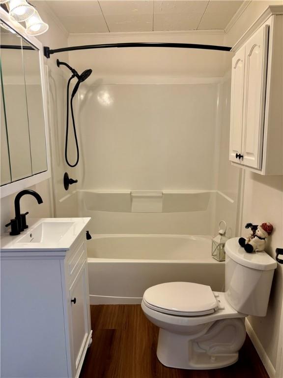 full bathroom with vanity, wood-type flooring, shower / bathtub combination, and toilet