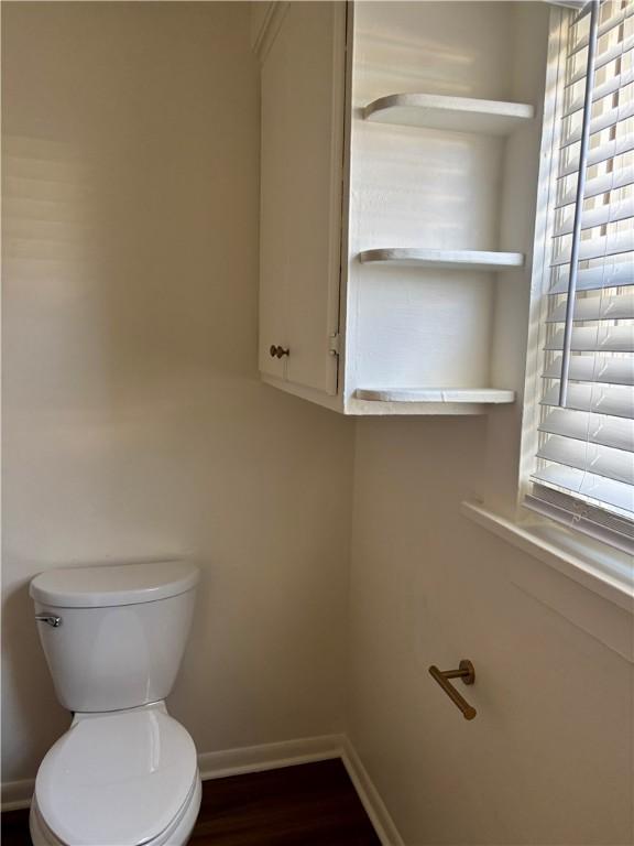 bathroom featuring hardwood / wood-style flooring and toilet