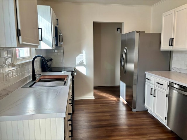 kitchen featuring white cabinetry, appliances with stainless steel finishes, sink, and dark wood-type flooring