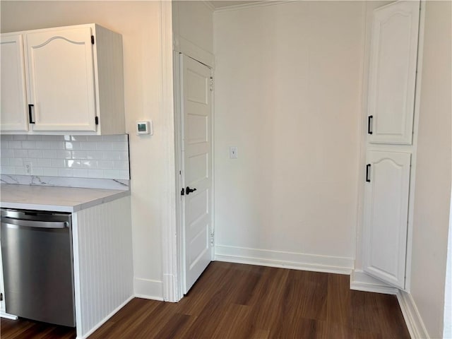 kitchen with white cabinetry, stainless steel dishwasher, dark hardwood / wood-style floors, and tasteful backsplash