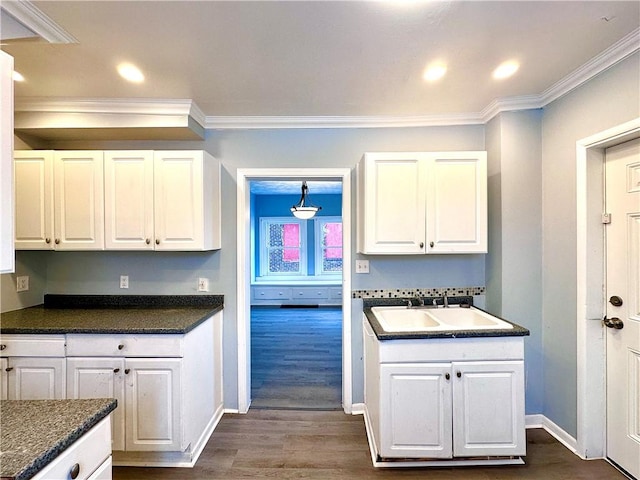 kitchen featuring sink, crown molding, dark hardwood / wood-style floors, and white cabinets