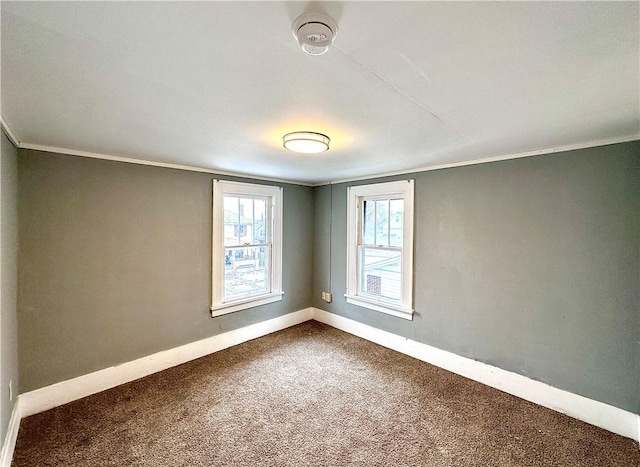 carpeted empty room featuring crown molding