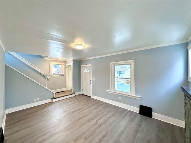 foyer entrance featuring wood-type flooring and ornamental molding