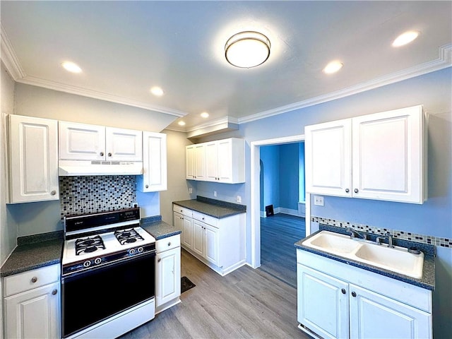 kitchen featuring white cabinetry, white range with gas cooktop, light wood-type flooring, and crown molding