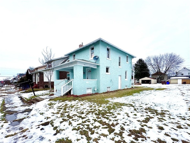 view of snow covered exterior with a porch