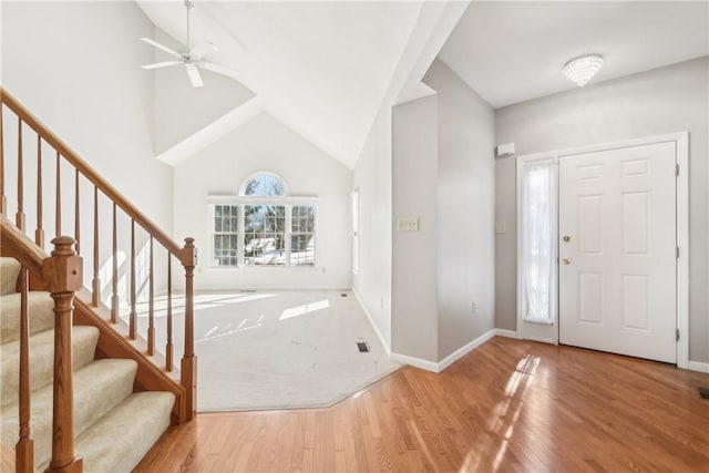 entrance foyer with hardwood / wood-style floors, high vaulted ceiling, and ceiling fan