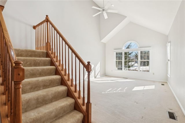 interior space featuring ceiling fan, high vaulted ceiling, and carpet floors