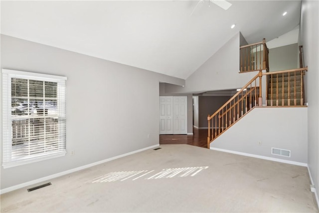 unfurnished living room with high vaulted ceiling, ceiling fan, and carpet flooring