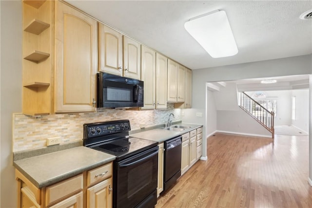 kitchen featuring decorative backsplash, sink, light brown cabinets, and black appliances