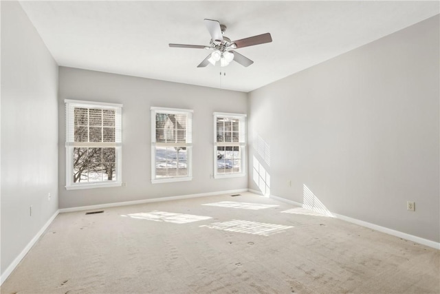 empty room with light colored carpet and ceiling fan