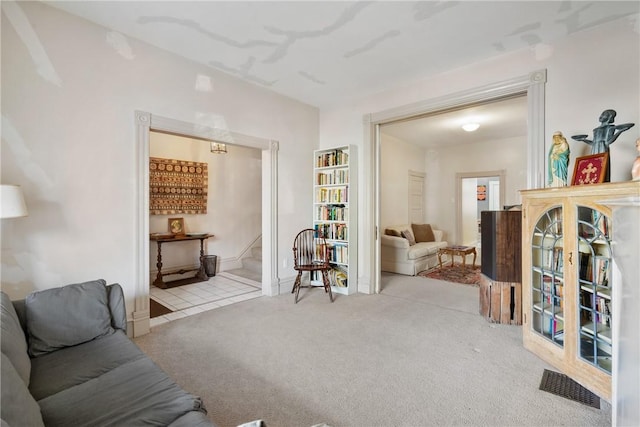 sitting room featuring light colored carpet