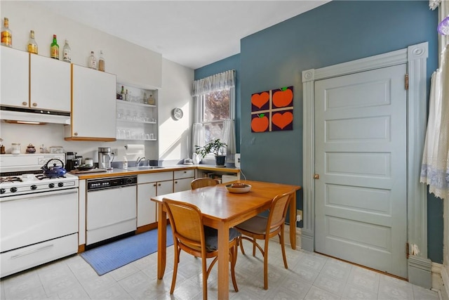 kitchen featuring white cabinetry, sink, and white appliances