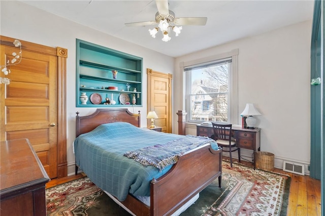 bedroom with dark wood-type flooring and ceiling fan