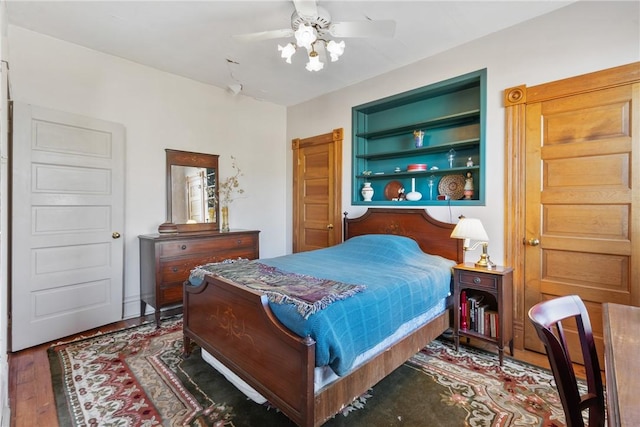 bedroom with dark hardwood / wood-style floors and ceiling fan