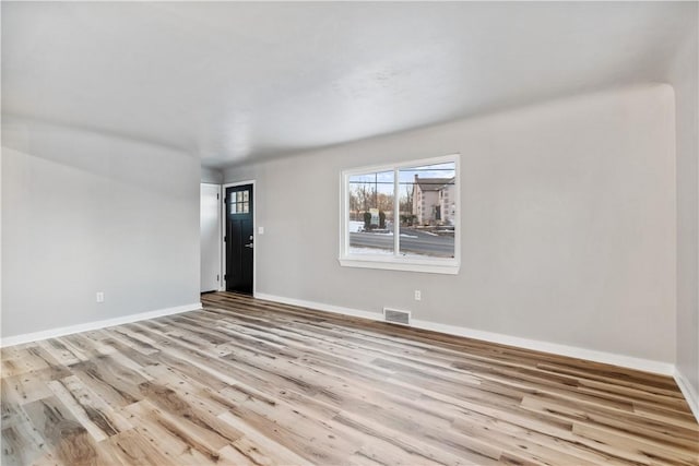 unfurnished room with light wood-type flooring