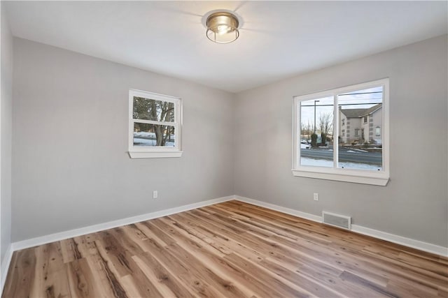 spare room featuring light hardwood / wood-style floors