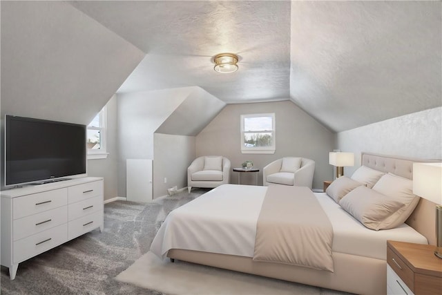 carpeted bedroom featuring vaulted ceiling and a textured ceiling