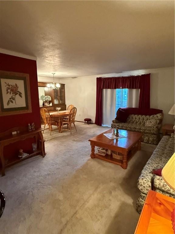 carpeted living room with a notable chandelier