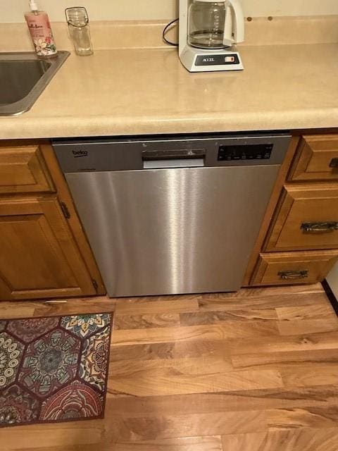 kitchen featuring sink, wood-type flooring, and dishwasher