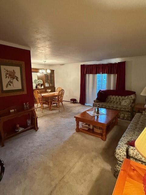 living room with an inviting chandelier and carpet flooring