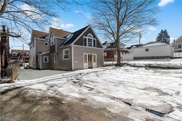 view of snow covered rear of property