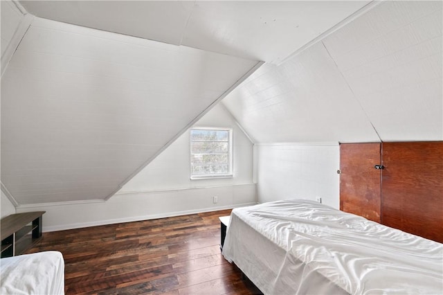 bedroom with dark wood-type flooring and vaulted ceiling