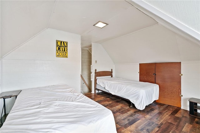 bedroom with lofted ceiling and dark hardwood / wood-style flooring