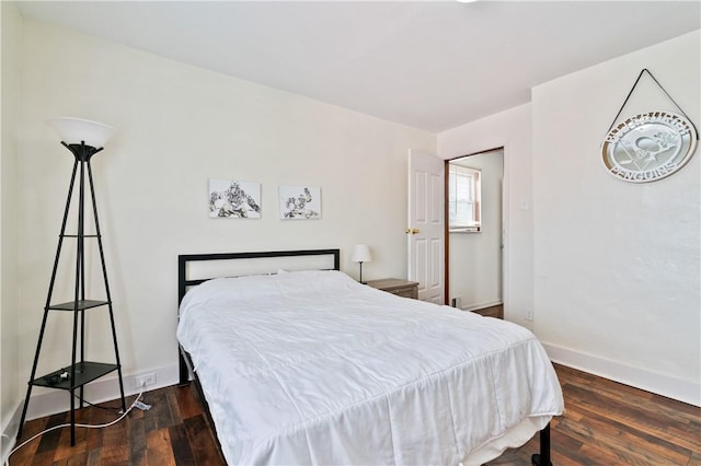 bedroom with dark hardwood / wood-style flooring