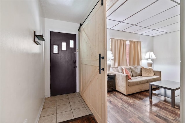 foyer featuring a barn door and hardwood / wood-style floors