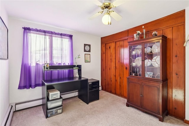 office space with a baseboard radiator, light carpet, and ceiling fan