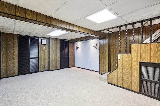 basement with light colored carpet and wood walls