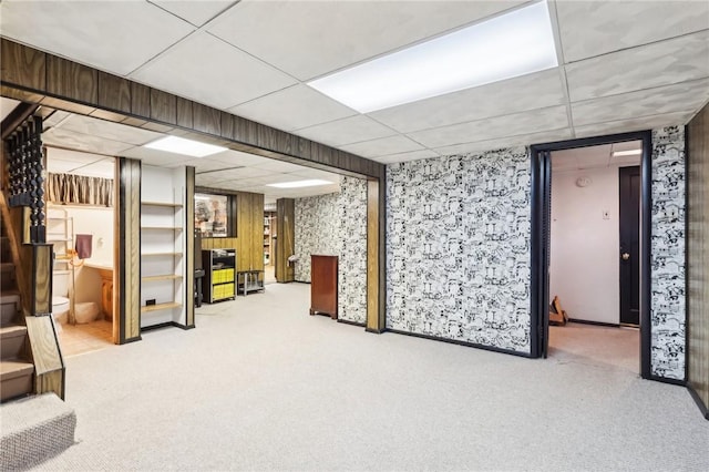 basement with carpet and a paneled ceiling