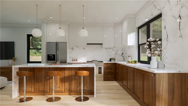 bar featuring white cabinetry, ornamental molding, pendant lighting, stainless steel appliances, and decorative backsplash