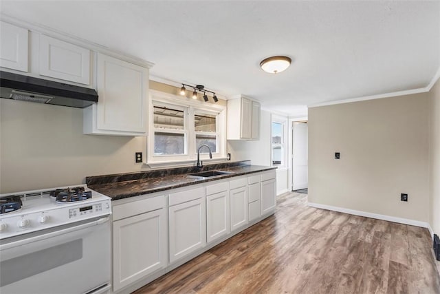 kitchen featuring sink, white range with gas stovetop, and white cabinets