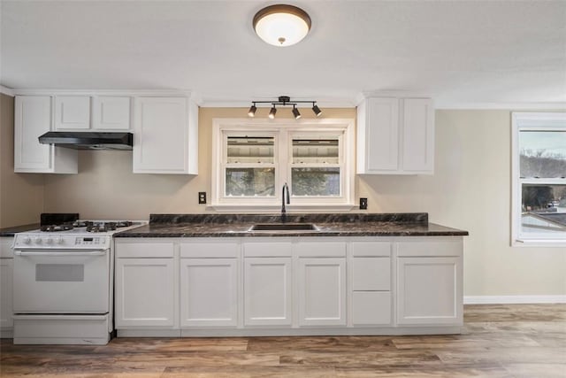 kitchen featuring white cabinetry, sink, and gas range gas stove