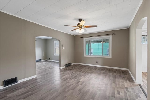 unfurnished room with ornamental molding, hardwood / wood-style floors, and ceiling fan