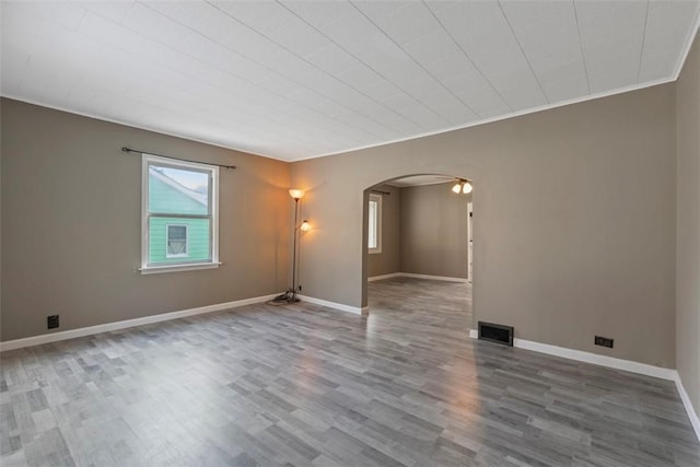 unfurnished room featuring hardwood / wood-style flooring and crown molding