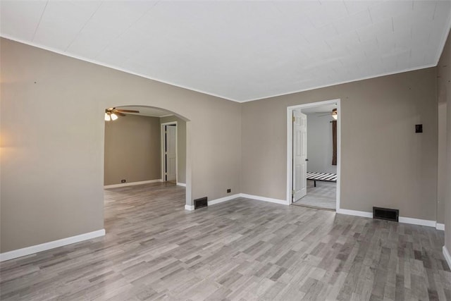 empty room featuring ceiling fan and light hardwood / wood-style floors