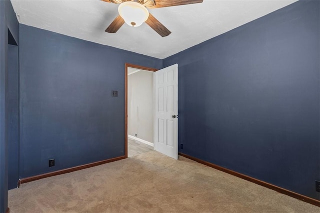 empty room with carpet floors and ceiling fan