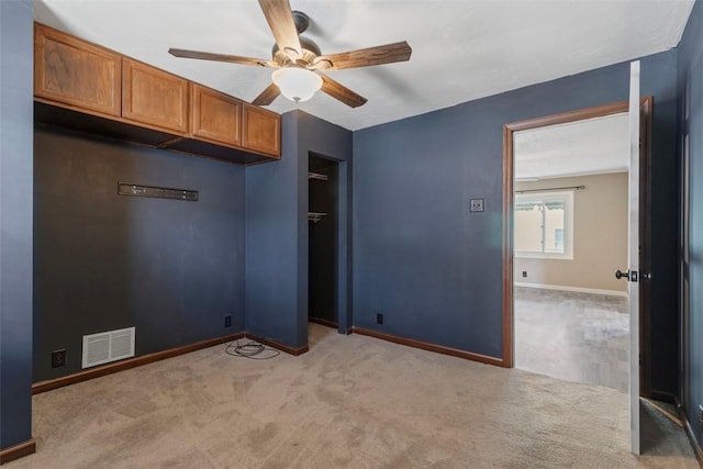 unfurnished bedroom featuring light colored carpet, ceiling fan, and a closet