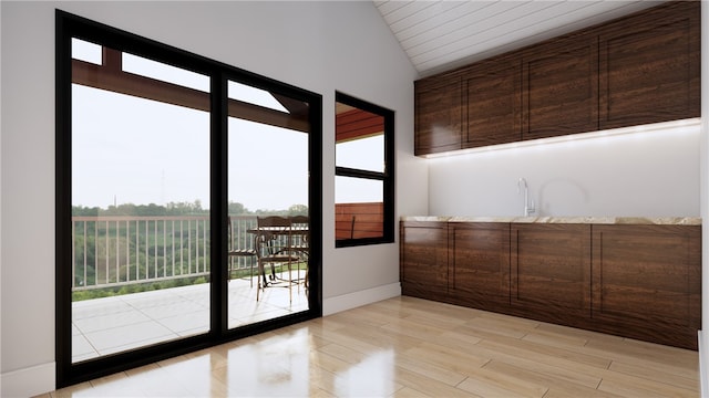 entryway featuring lofted ceiling and light hardwood / wood-style floors