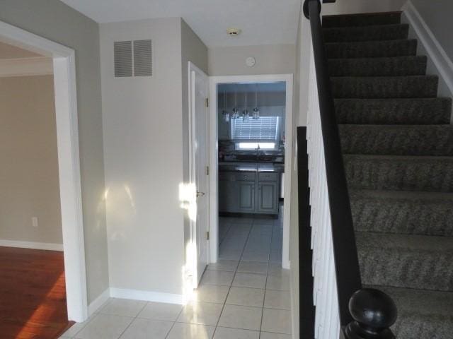 stairway featuring tile patterned floors