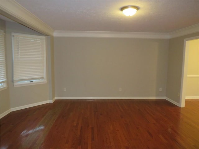 spare room featuring crown molding and dark hardwood / wood-style floors