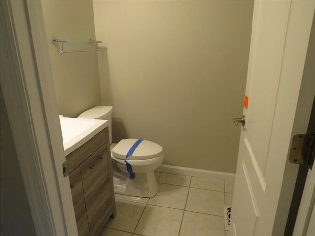 bathroom featuring vanity, toilet, and tile patterned flooring