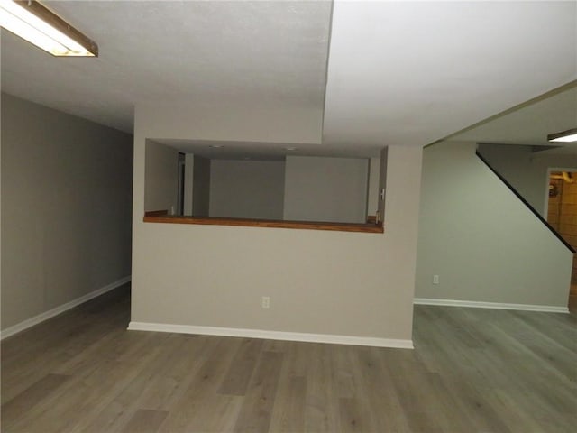 basement with light hardwood / wood-style floors