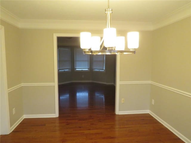 unfurnished dining area with an inviting chandelier, dark wood-type flooring, and ornamental molding